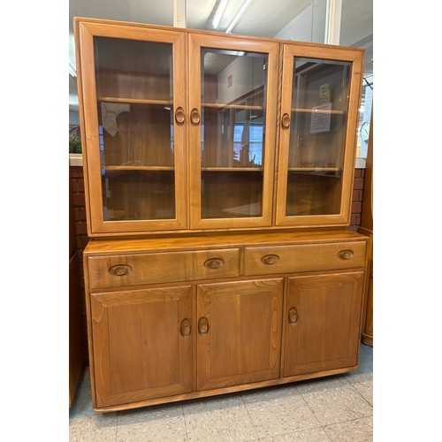 23I - An Ercol Blonde elm Windsor bookcase