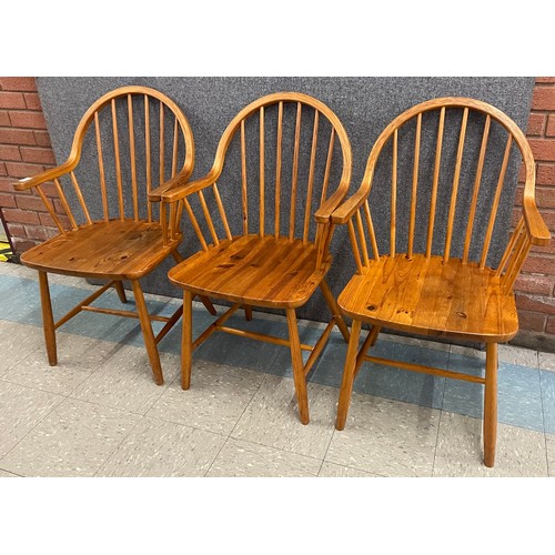 49 - A set of three Danish Tarm Stole Mobelfabrik pine elbow chairs, designed by Erik Ole Jørgensen