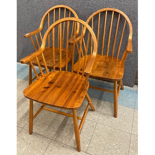 49 - A set of three Danish Tarm Stole Mobelfabrik pine elbow chairs, designed by Erik Ole Jørgensen