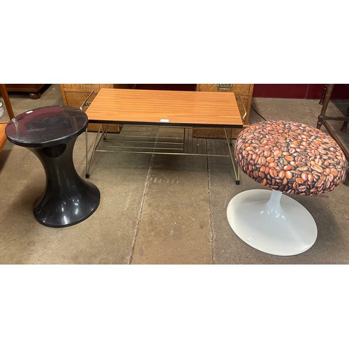 48 - A teak and metal coffee table and two tulip shaped stools