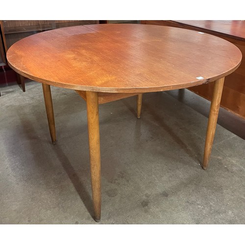 38 - A Danish teak circular extending dining table