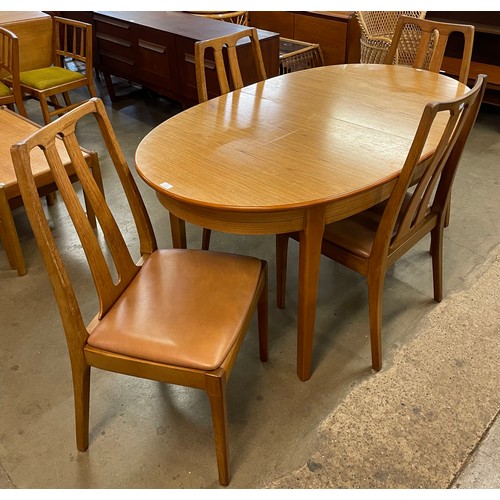 33 - A teak oval extending dining table and four chairs