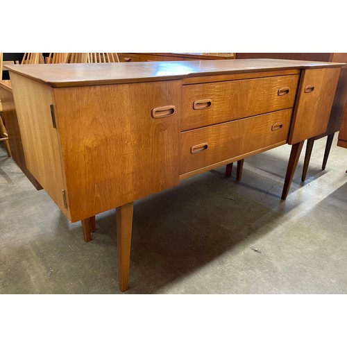 26 - A teak breakfront sideboard