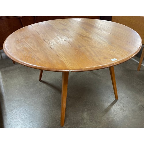 23 - An Ercol Blonde elm and beech Windsor drop leaf table