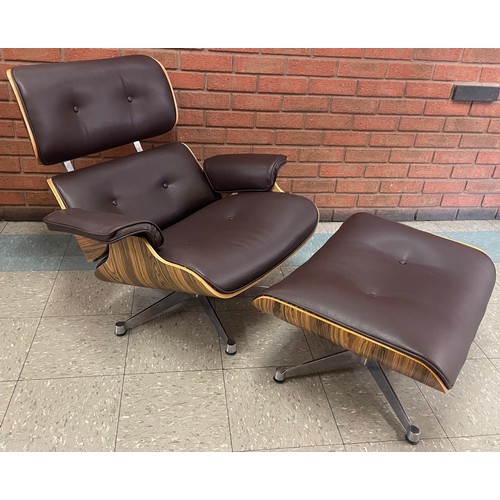 17 - A Charles & Ray Eames style simulated rosewood and black leather revolving lounge chair and ottoman