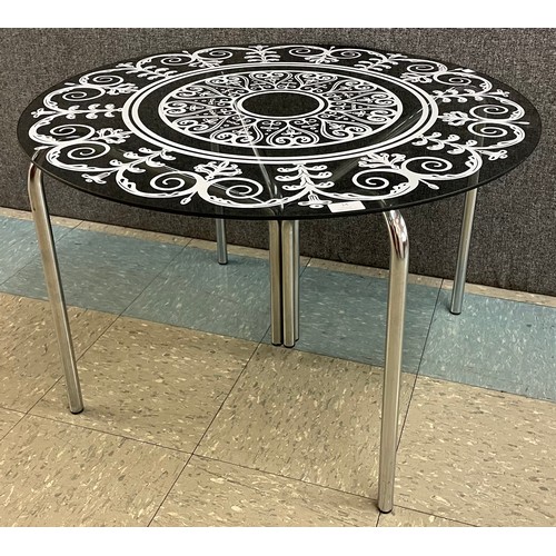 14 - A chrome and glass topped circular coffee table