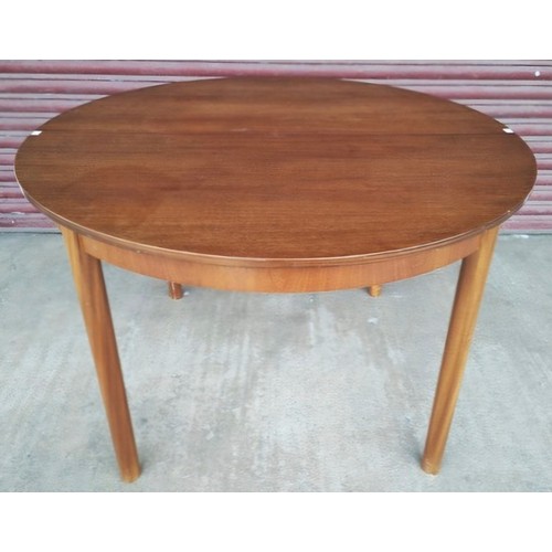 9A - A McIntosh Dunbar teak circular extending dining table