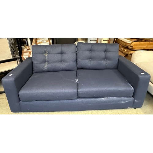 1573 - A blue upholstered three seater sofa - damaged