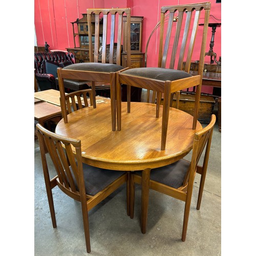 45 - A Meredew teak circular extending dining table and six chairs