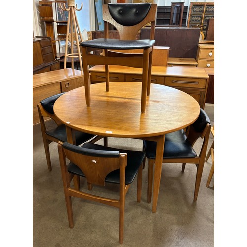 15 - A teak circular extending dining table and four chairs