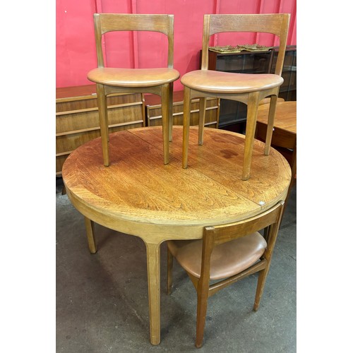 40B - A Nathan teak circular extending dining table and four chairs