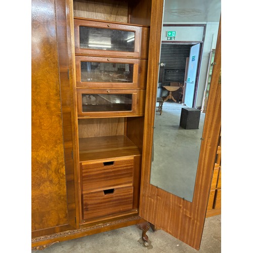 146 - A Queen Anne style walnut three door wardrobe