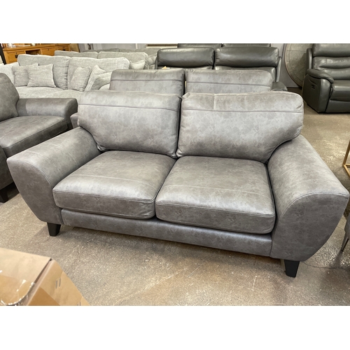 1465 - A charcoal PU leather three seater sofa