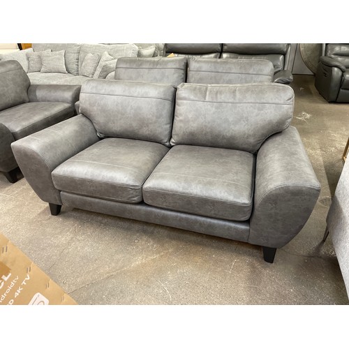 1464 - A charcoal PU leather three seater sofa