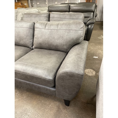 1464 - A charcoal PU leather three seater sofa