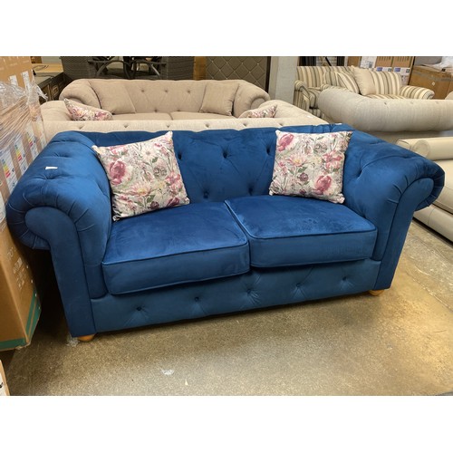 1467 - A blue velvet Chesterfield three seater sofa - RRP £1379.00