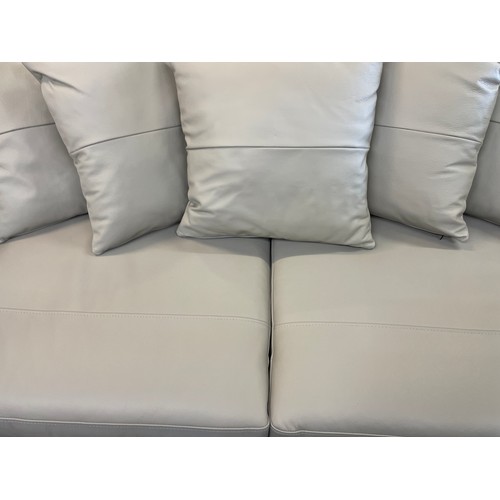 1468 - A stone leather three seater sofa