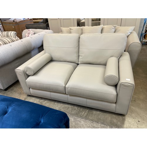 1470 - A stone leather two seater sofa