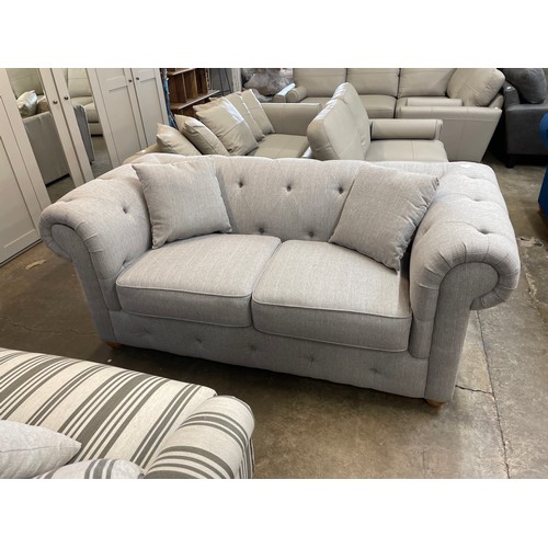 1473 - A grey weave Chesterfield three seater sofa RRP £1379