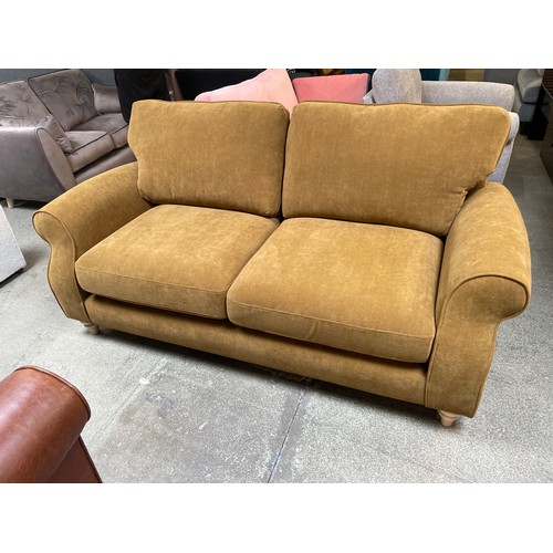 1479 - An Ochre velvet three seater sofa