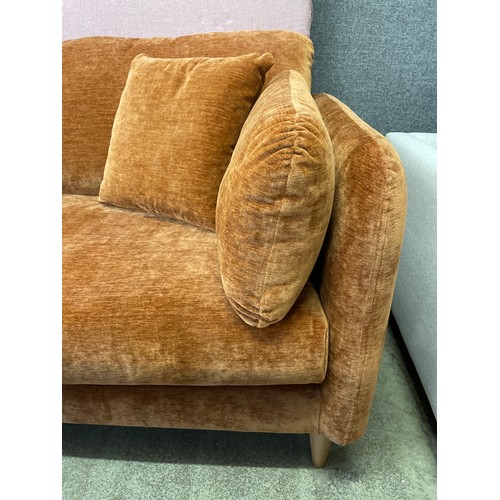 1481 - An ochre velvet three seater sofa