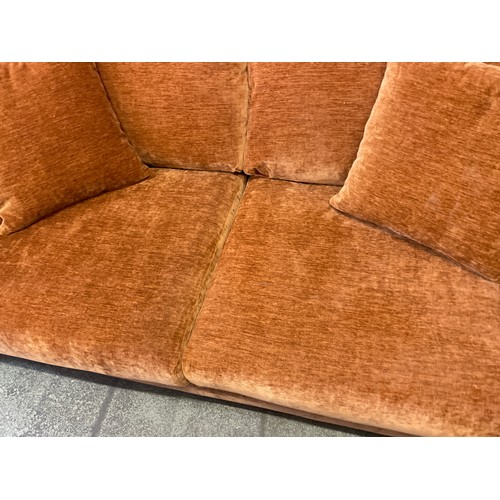 1481 - An ochre velvet three seater sofa