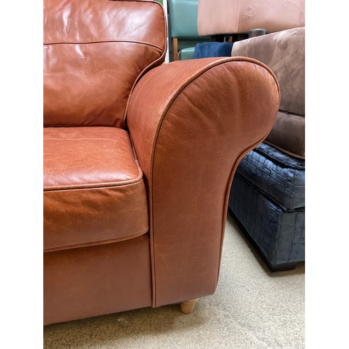 1487 - A tan leather armchair