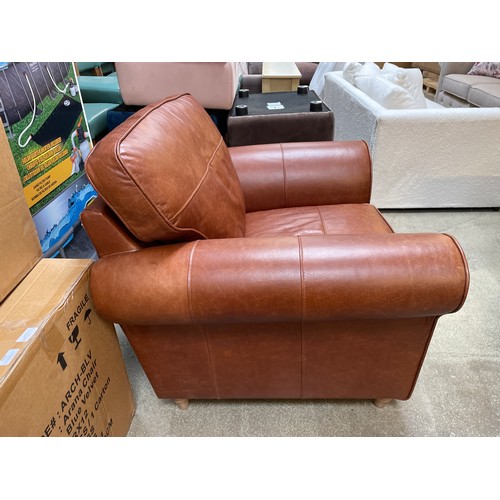 1487 - A tan leather armchair