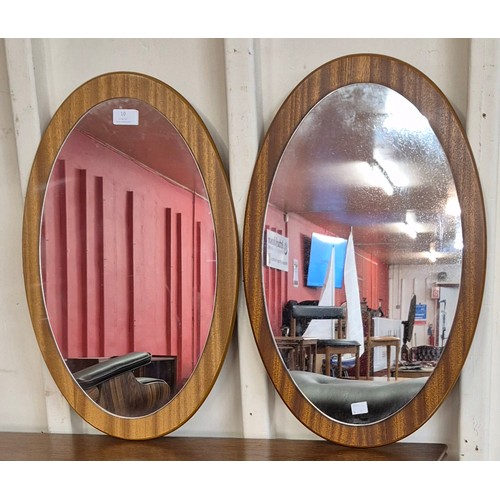 10 - A pair of oval teak framed mirrors