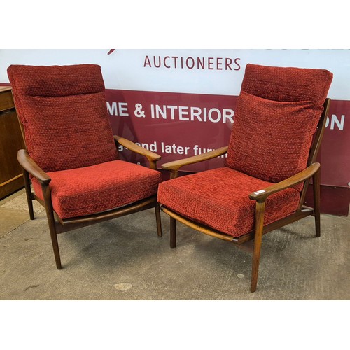 46 - A pair of Guy Rogers teak New Yorker armchairs. Please note this lot is being sold as a work of art.... 