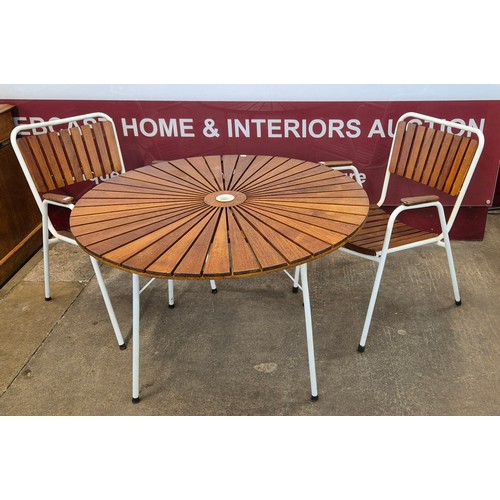 47 - A Danish Daneline teak and white tubular metal circular garden table and two chairs