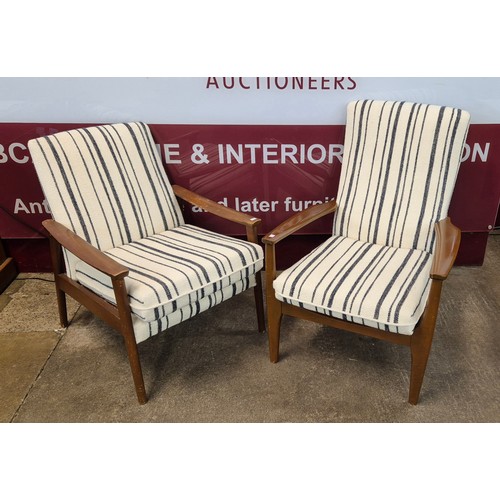 62 - A pair of Parker Knoll teak and fabric upholstered cocktail lounge chairs