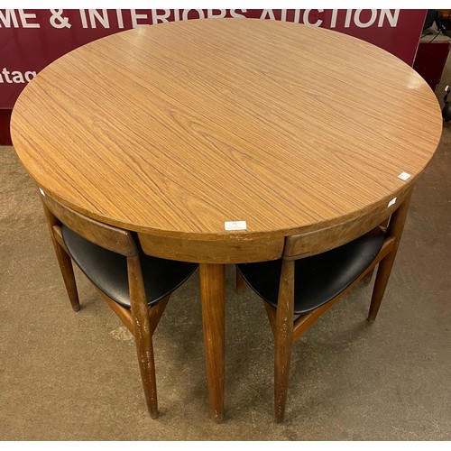 73 - A Danish Frem Rojle teak and rosewood effect Roundette dining table and four chairs, designed by Han... 