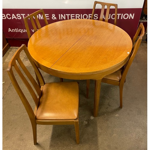 74 - A Nathan teak circular extending table and four chairs