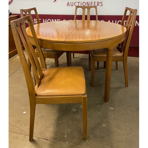 74 - A Nathan teak circular extending table and four chairs