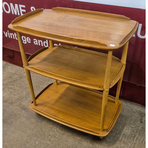 84 - An Ercol Blonde elm and beech Windsor trolley