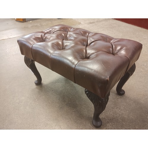 130 - A chestnut brown leather upholstered footstool