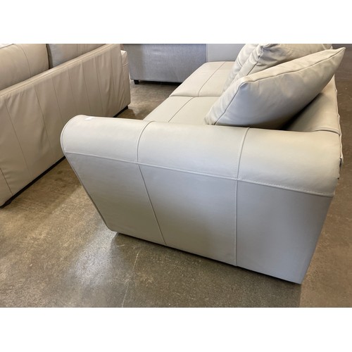 1377 - A stone leather three seater sofa