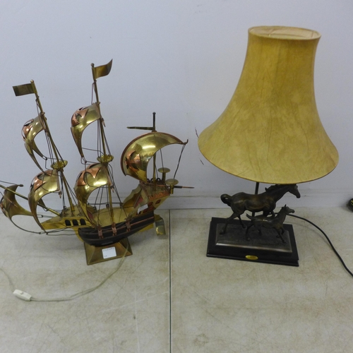 2081 - A decorative brass model of a galleon ship with LED lights and a bronze effect horse and calf themed... 