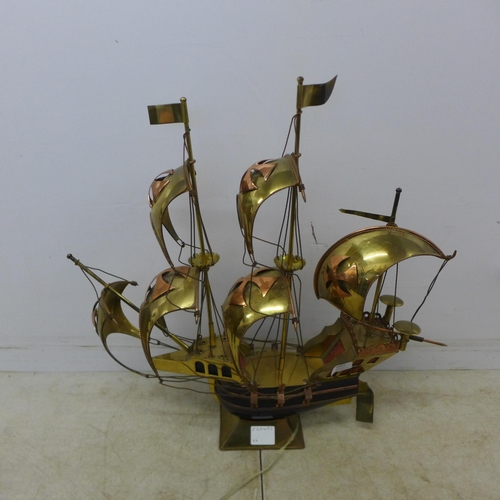 2081 - A decorative brass model of a galleon ship with LED lights and a bronze effect horse and calf themed... 