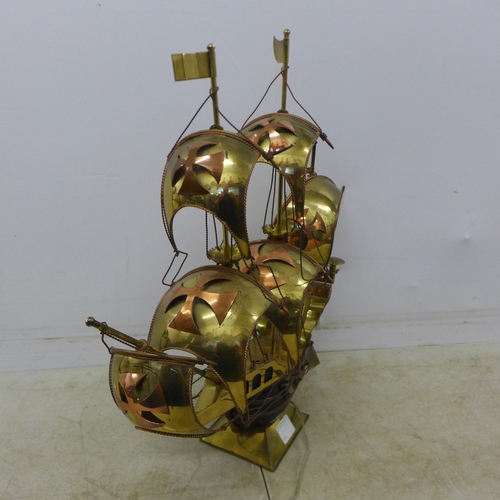 2081 - A decorative brass model of a galleon ship with LED lights and a bronze effect horse and calf themed... 