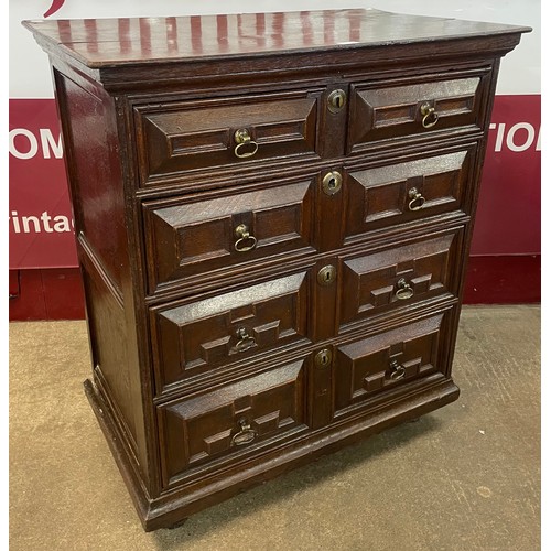 112 - A Charles II oak geometric moulded chest of drawers