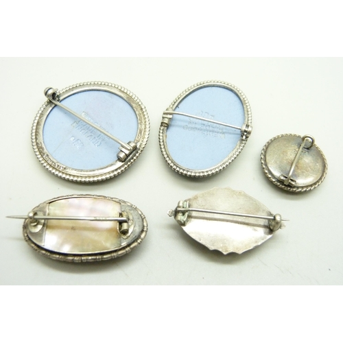 1024 - Five brooches including a silver butterfly wing brooch and two Wedgwood, two a/f