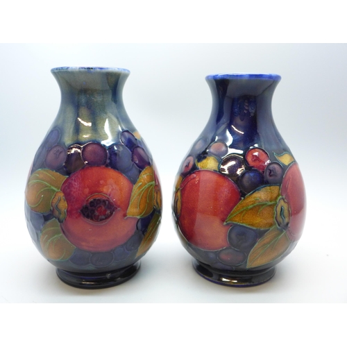 616 - Two Moorcroft vases, one open pomegranate design, 12cm, both signed, one a/f, hairline crack on rim