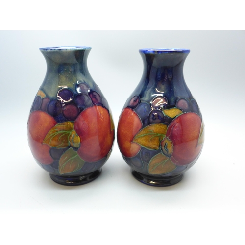 616 - Two Moorcroft vases, one open pomegranate design, 12cm, both signed, one a/f, hairline crack on rim