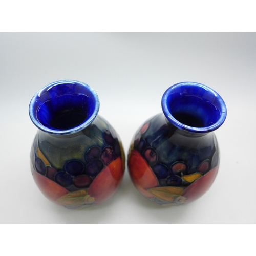 616 - Two Moorcroft vases, one open pomegranate design, 12cm, both signed, one a/f, hairline crack on rim