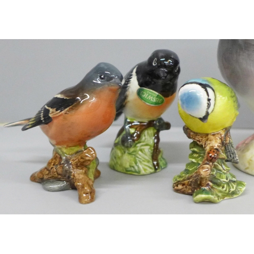 637 - Four Beswick model birds; Pigeon, Chaffinch, Blue Tit and Stonechat