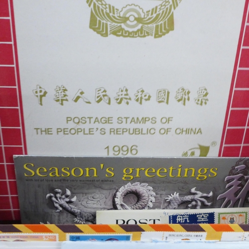 696 - A box of three China special stamp books and a few items of postal history