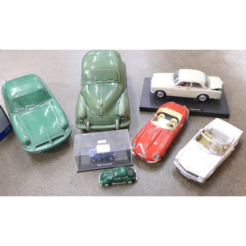 706 - Four 1/18 scale diecast model vehicles, two others and two ceramic motor cars