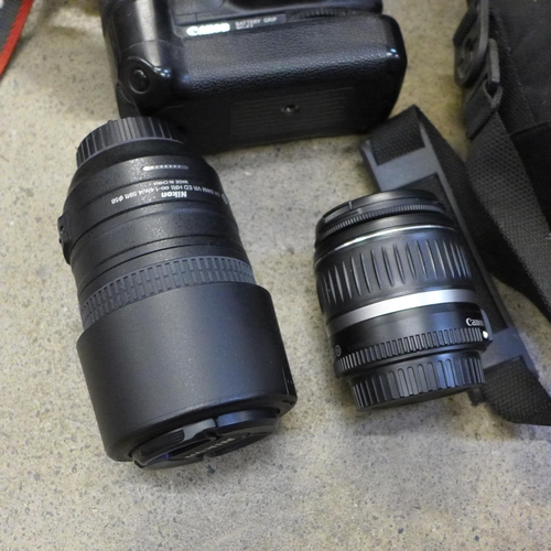 715 - A Canon EOS 40D camera with winder, Canon EOS 1000D camera, a Nikon AF-S Nikkor 55-300mm 1:4.5-1:3.5... 